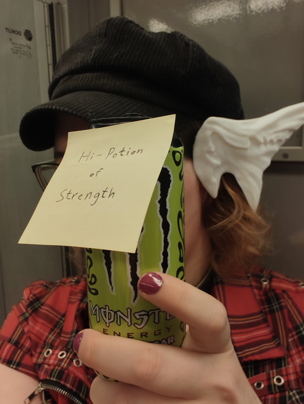 I'm on the U-Bahn, with white (Raen) Au Ra horns, my face covered by a can of Monster labelled "Hi-Potion of Strength"